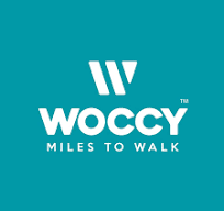 Desk with leather desk pad, walnut desk organizer, wireless keyboard and mouse, and porcelain mug.