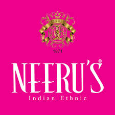 Desk with leather desk pad, walnut desk organizer, wireless keyboard and mouse, and porcelain mug.