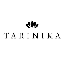 Desk with leather desk pad, walnut desk organizer, wireless keyboard and mouse, and porcelain mug.