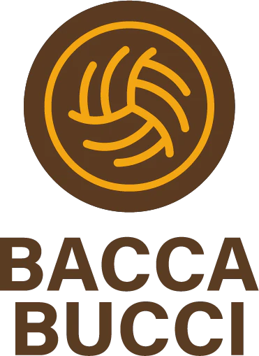 Desk with leather desk pad, walnut desk organizer, wireless keyboard and mouse, and porcelain mug.