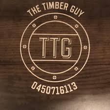 Desk with leather desk pad, walnut desk organizer, wireless keyboard and mouse, and porcelain mug.