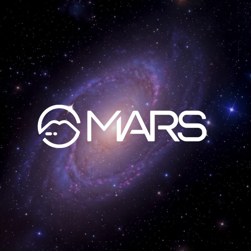 Desk with leather desk pad, walnut desk organizer, wireless keyboard and mouse, and porcelain mug.