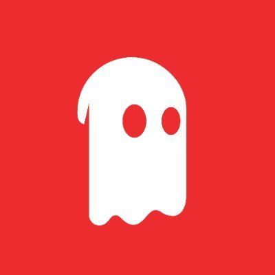 Desk with leather desk pad, walnut desk organizer, wireless keyboard and mouse, and porcelain mug.